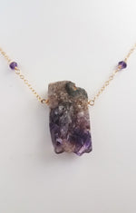 Raw Amethyst Nugget Pendant is Surrounded by Faceted Amethyst roundel on Gold-Filled Chain.