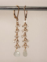 Faceted Aquamarine Tear Drop Dangles Off a Cascade of Faceted Moonstones on 14 kt Gold-Filled Lever Back Earrings.