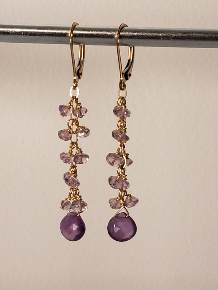 Faceted Amethyst Tear Drop Anchors a Cascade of Amethyst Gemstones on 14kt Gold-Filled Lever Back Earrings.