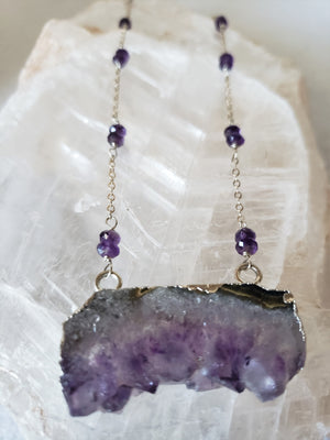 Raw Amethyst Slice Pendant Surrounded By Faceted Amethyst Stones On Sterling Silver Chain Promotes Spiritual Consciousness.