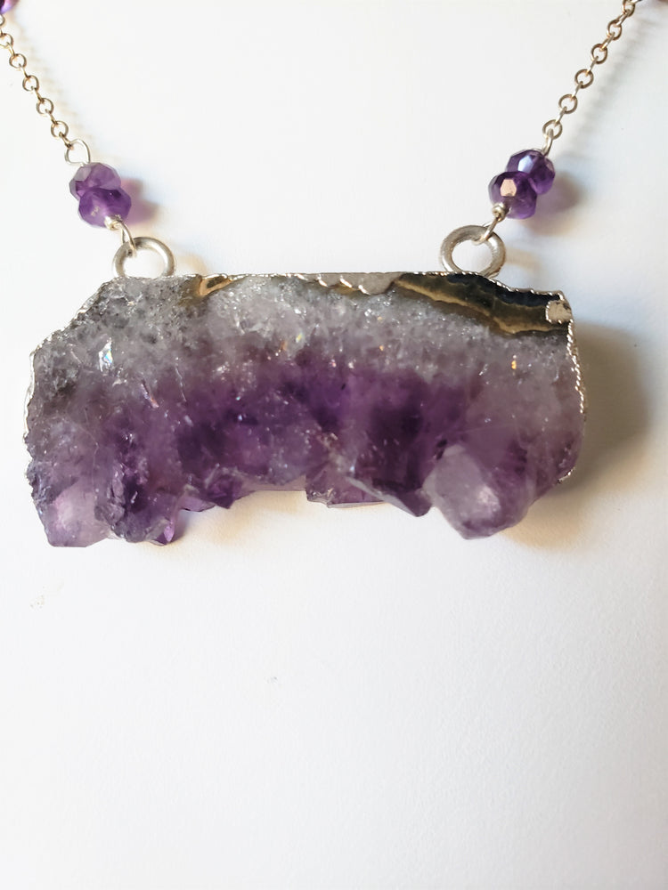 Raw Amethyst Slice Pendant Surrounded By Faceted Amethyst Stones On Sterling Silver Chain Promotes Spiritual Consciousness.