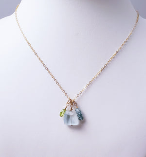 Aquamarine Faceted Gemstone is Surrounded by Amethyst and Apatite Faceted Gemstones to Form a Cluster of Sparkle.