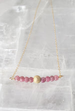 Delicate Bar Necklace Features Faceted Pink Tourmaline Surrounded By a Gold-Filled Sparkle Ball To Form On Gold-Filled Chain Encourages Unconditional Love.